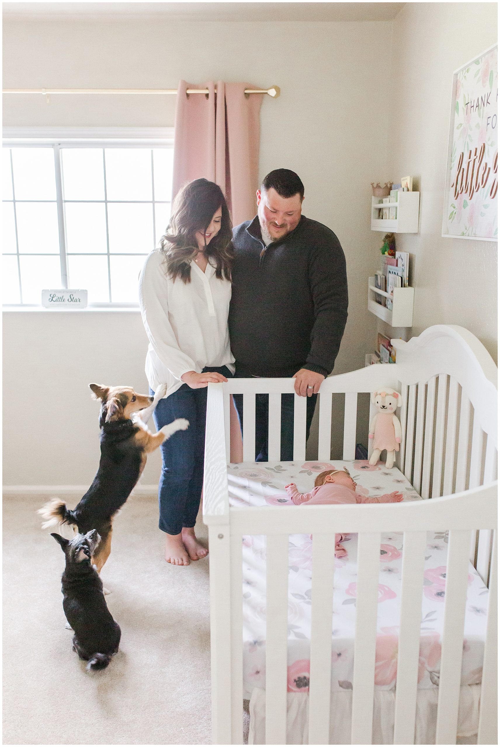 In Home Newborn Lifestyle Session Parents Looking in Crib with Dogs | Jessica + Anthony
