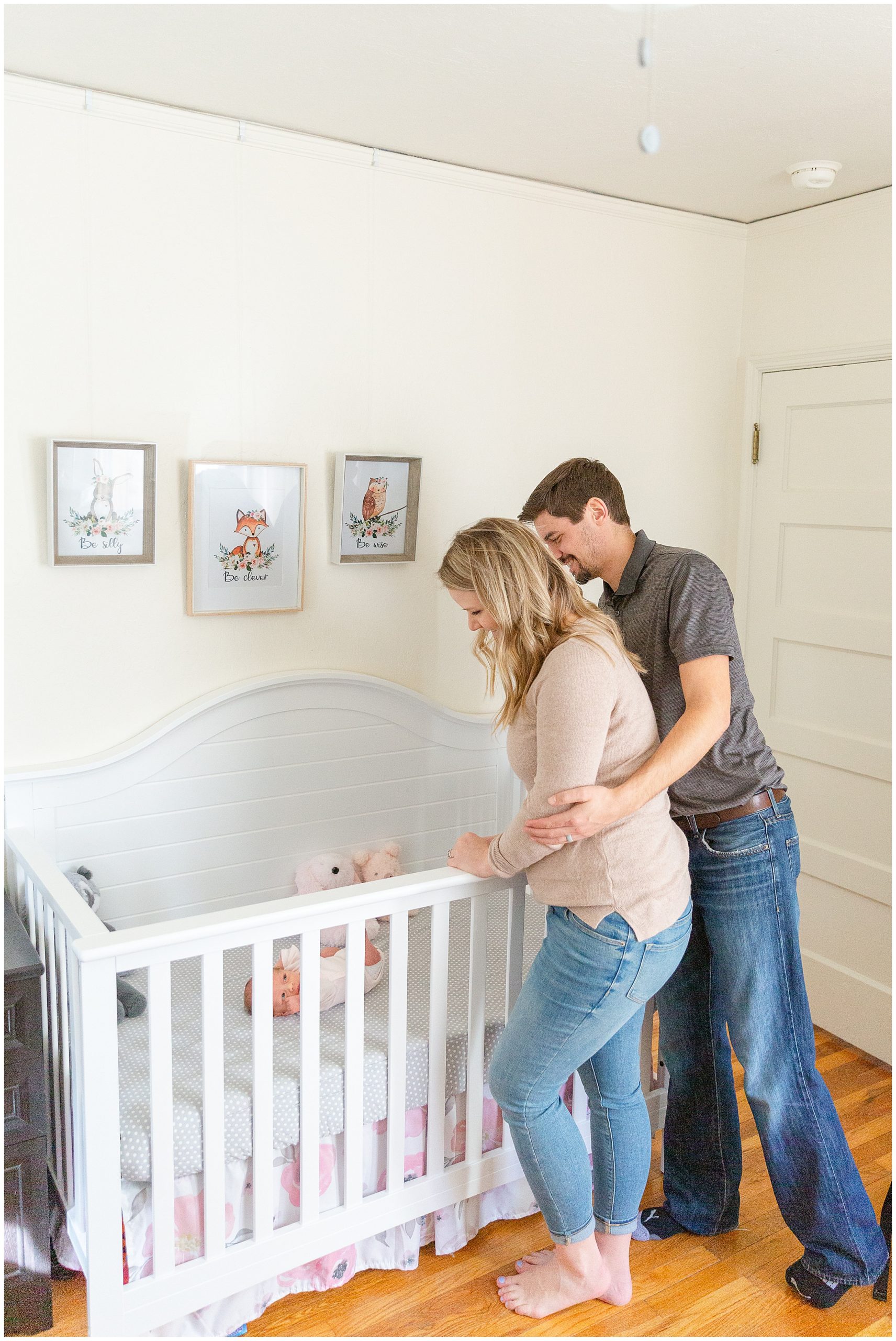 In Home Newborn Lifestyle Session Parents Over Crib | Stephanie and Hobie