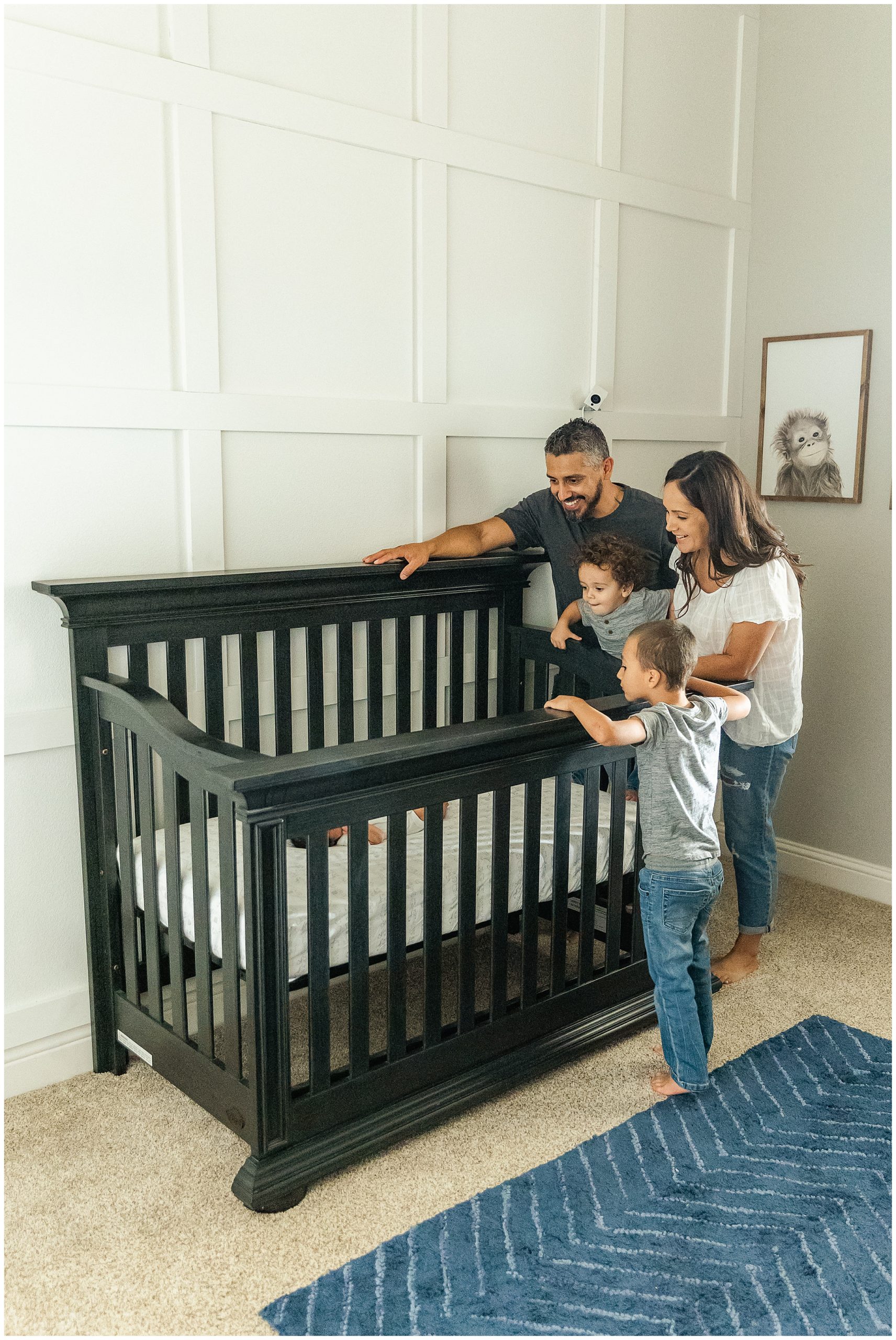 Family Surrounding Newborn Baby in Crib | Natalie + Eddie