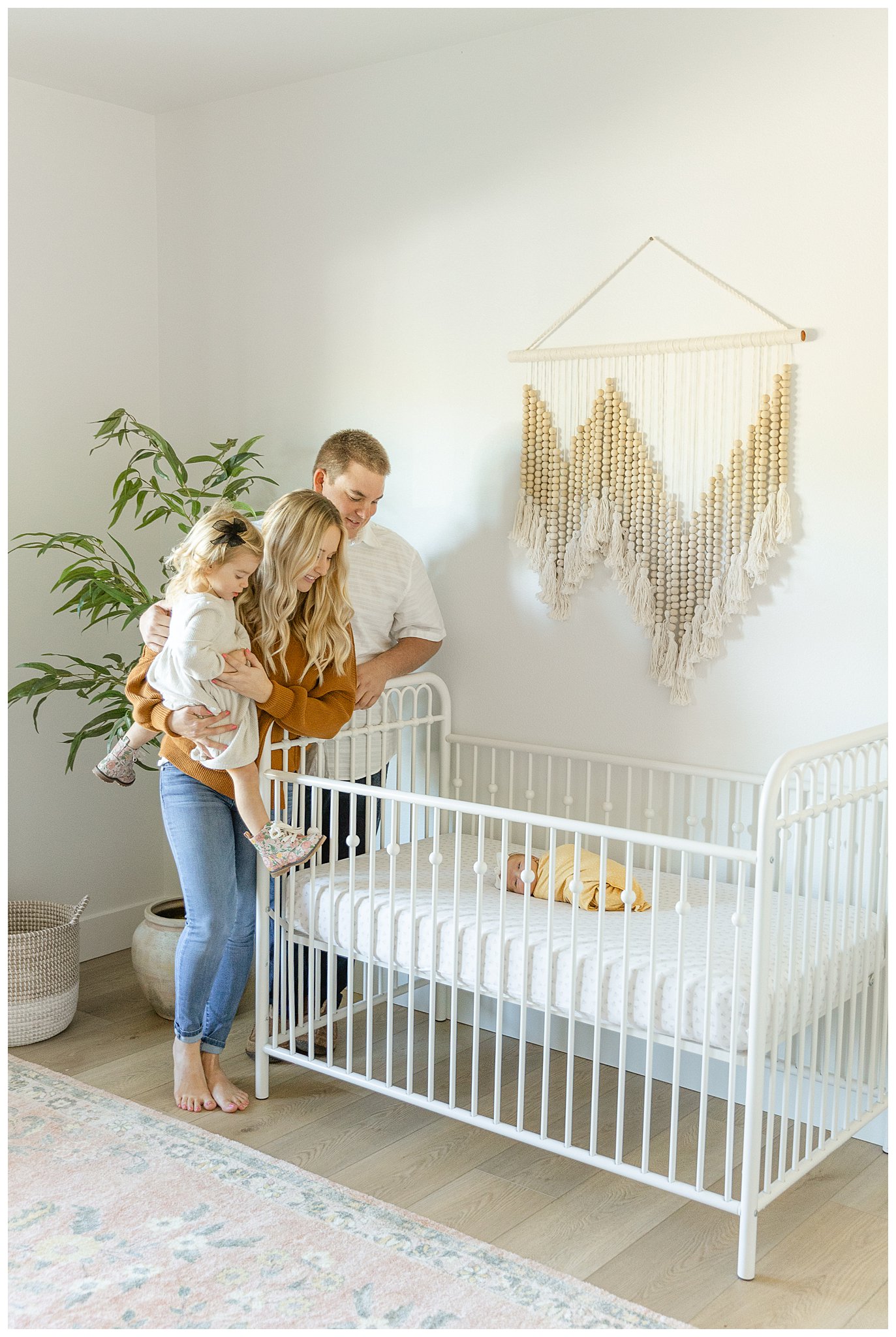 Baby Makes Four Family Adoring Newborn in Crib | Heather + Danny